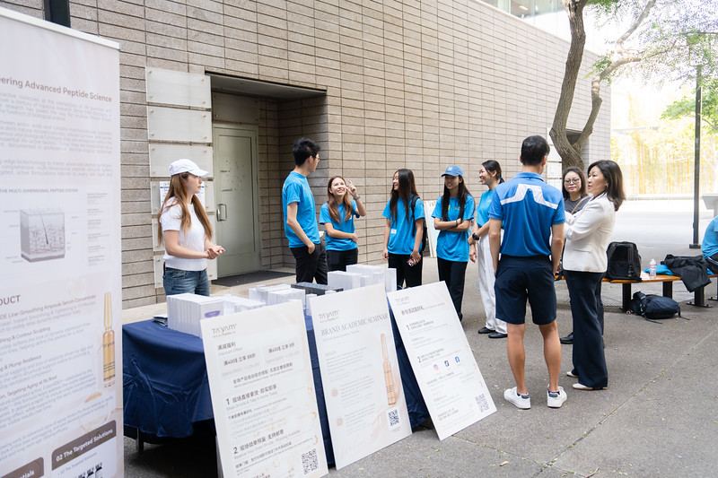 Students presenting research posters outdoors